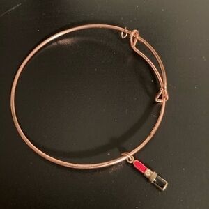 Brass colored bracelet with charm